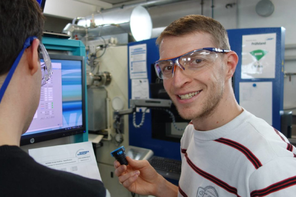 NORMA Group employee inspects a quick connector